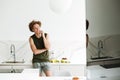 Man standing at the kitchen and talking by phone Royalty Free Stock Photo