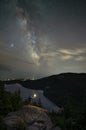 Man standing a ledge over looking Jordan Pond and the Milky Way Galaxy Royalty Free Stock Photo