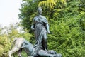 A man standing on a lion Statue of historic Bismarck Memorial in the Tiergarten in Berlin, Germany.