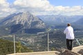 Man looking at a panorama of a small town Banff in a Bow river valley Royalty Free Stock Photo