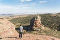 Man standing and looking at a Rodeno Boulder in Perecense, Teruel, Spain