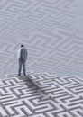 Man standing on a maze against background with mazes Royalty Free Stock Photo