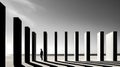 Man is standing in the middle of row of tall pillars in black and white photo. Generative AI Royalty Free Stock Photo