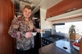 Man standing in motor home holding coffee in cezve and cup