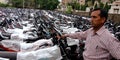 Man standing in motorcycles parking stand at yard Royalty Free Stock Photo