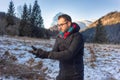 Man standing on mountain adding handgloves Royalty Free Stock Photo