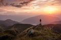 Man standing on a mountain summit at sunset Royalty Free Stock Photo