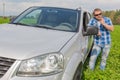 Man standing near car leaned on door Royalty Free Stock Photo