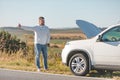 man standing near car with opened hood on sunset Royalty Free Stock Photo