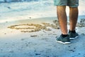 Man standing next to his message on the sand next to the sea at sunset, Rhodes, Greece Royalty Free Stock Photo