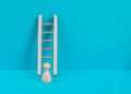 Man is standing next to a ladder, climbing up in career, having a goal, brainstorming for ideas, success strategy, challenge