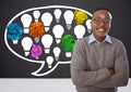 Man standing next to light bulbs chat bubble with crumpled paper balls in front of blackboard Royalty Free Stock Photo