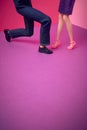 The man is standing on one knee. Couple, dolls on a pink purple background. Text space. Proposal, engagement, romance, concept. Royalty Free Stock Photo