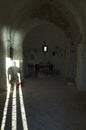 Man standing in open door way with light shining into small church Royalty Free Stock Photo