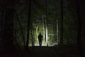 Man standing outdoor at dark night shining with flashlight Royalty Free Stock Photo