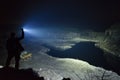 Man standing outdoor at rainy foggy night shining with flashlight Royalty Free Stock Photo