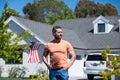 Man standing outside new american home. Handsome confident businessman in t shirt, looking up. Royalty Free Stock Photo