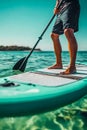 A man standing on a paddle board in the ocean Royalty Free Stock Photo