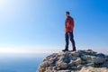 Man standing at the peak of rock mountain Royalty Free Stock Photo