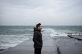 The man is standing on the pier facing the wind Royalty Free Stock Photo