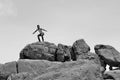 Man standing on pile of rocks -B&W- Royalty Free Stock Photo