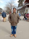 A man standing on the road very crowdy and beautiful place