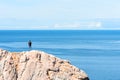 Man standing on a rock at the end of earth. Hiking or travel concept. Explore the great outdoors. Beauty of nature Royalty Free Stock Photo