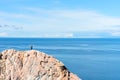 Man standing on a rock at the end of earth. Hiking or travel concept. Explore the great outdoors. Beauty of nature Royalty Free Stock Photo