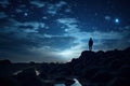 Man standing on a rock and looking at the night starry sky, silhouette of a person on rocks looking at the night sky with vialla Royalty Free Stock Photo