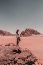 Man standing on the rocky hill in Wadi rum, Jordan Royalty Free Stock Photo