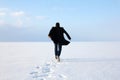 Man standing on the shore of a frozen sea downshifting way relax