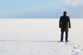 Man standing on the shore of a frozen sea downshifting way relax