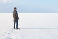 Man standing on the shore of a frozen sea downshifting way relax