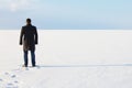 Man standing on the shore of a frozen sea downshifting way relax