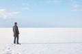 Man standing on the shore of a frozen sea downshifting way relax