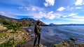 a man standing on the shores of lake toba, north sumatra, indonesia