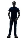 Man standing smiling with thumbs in pockets silhouette