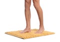 Man standing on soft yellow bath mat against white background, closeup Royalty Free Stock Photo