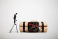 Man standing on the stepladder and looking at big bomb Royalty Free Stock Photo