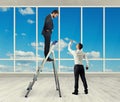 Man standing on stepladder and looking