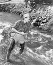 Man standing in a stream of water fishing Royalty Free Stock Photo