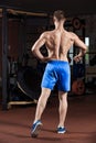 Man standing strong in the gym and flexing muscles Royalty Free Stock Photo