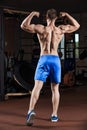 Man standing strong in the gym and flexing muscles Royalty Free Stock Photo