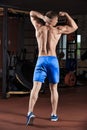 Man standing strong in the gym and flexing muscles Royalty Free Stock Photo