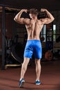 Man standing strong in the gym and flexing muscles Royalty Free Stock Photo