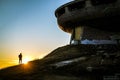 A man standing in the sunset at Buzludzha Monument,