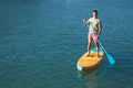Man standing on the supboard in ocean. Royalty Free Stock Photo