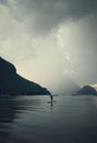 A man standing on a surf board and a storm coming. Royalty Free Stock Photo