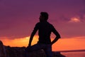 Man standing thinking back light sunset lighting side view profile silhouette summer evening beach