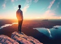 Man standing on top of cliff at sunset. Generated AI Royalty Free Stock Photo